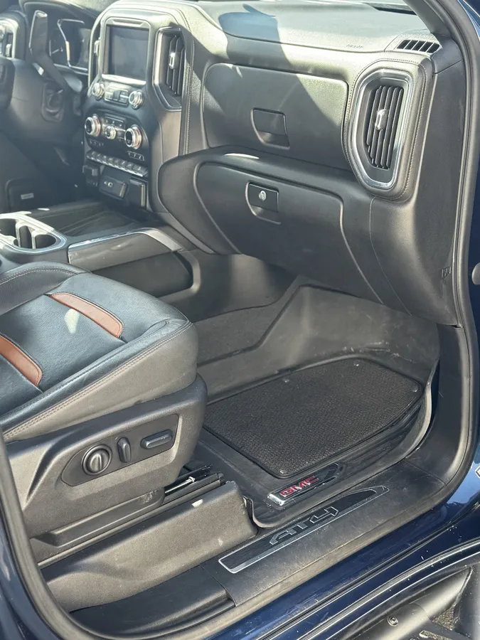 Cleaned passenger footwell and dash of a GMC Sierra AT4 after a full interior detail