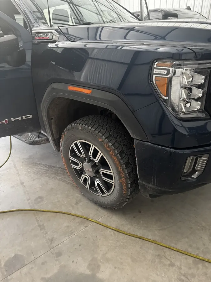 Dark blue GMC Sierra HD Duramax after an exterior hand wash at the Chickasha shop